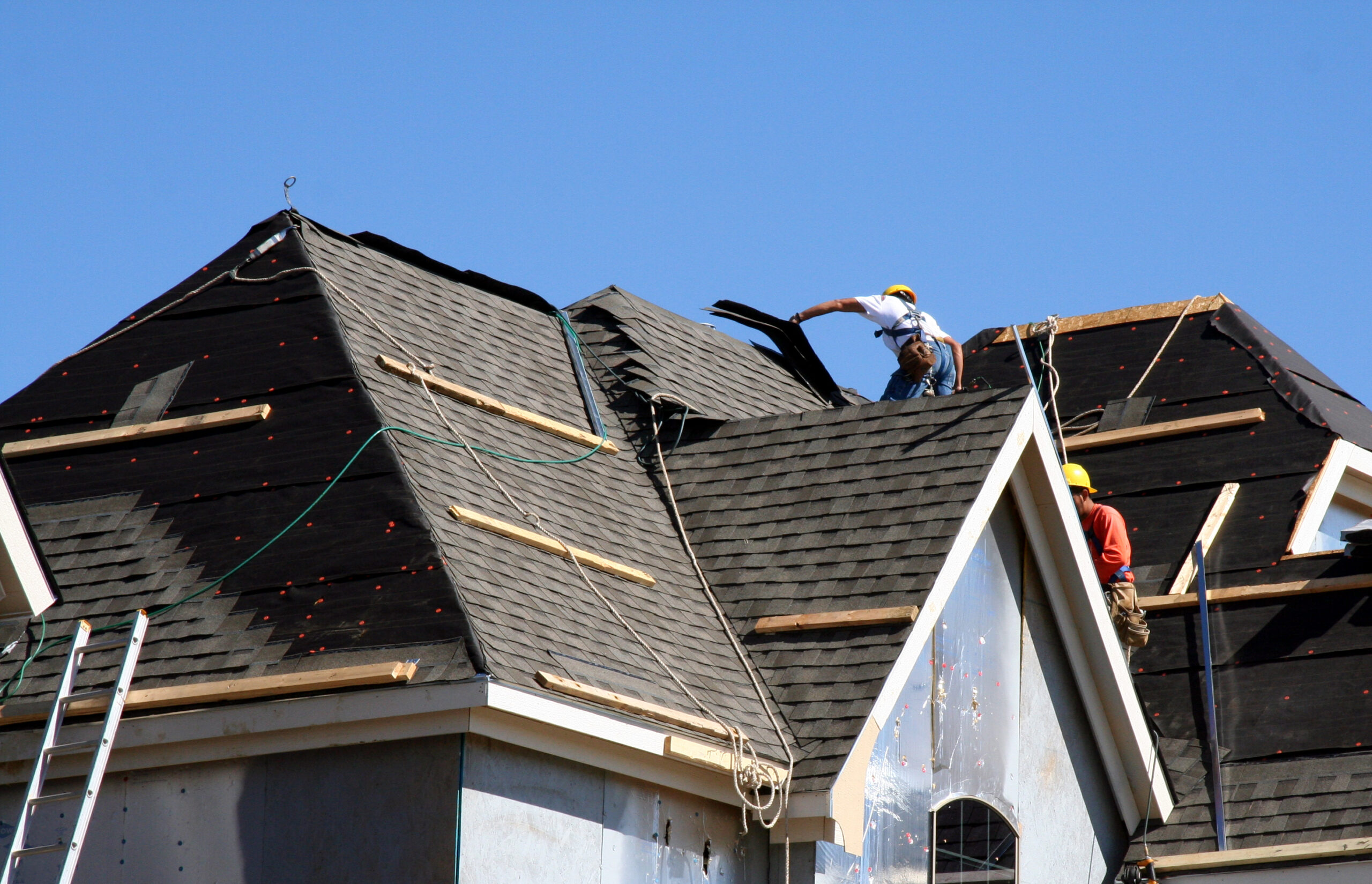 Roofing contractors working on a residential roof